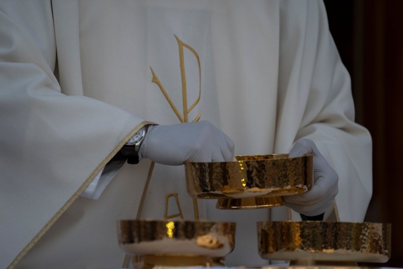 A Catholic Priest with the Eucharist