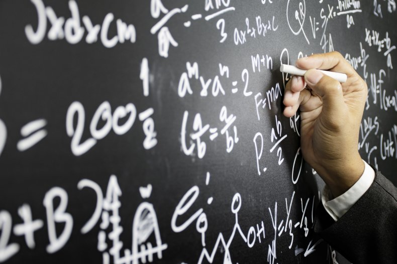 Teacher writing on a blackboard