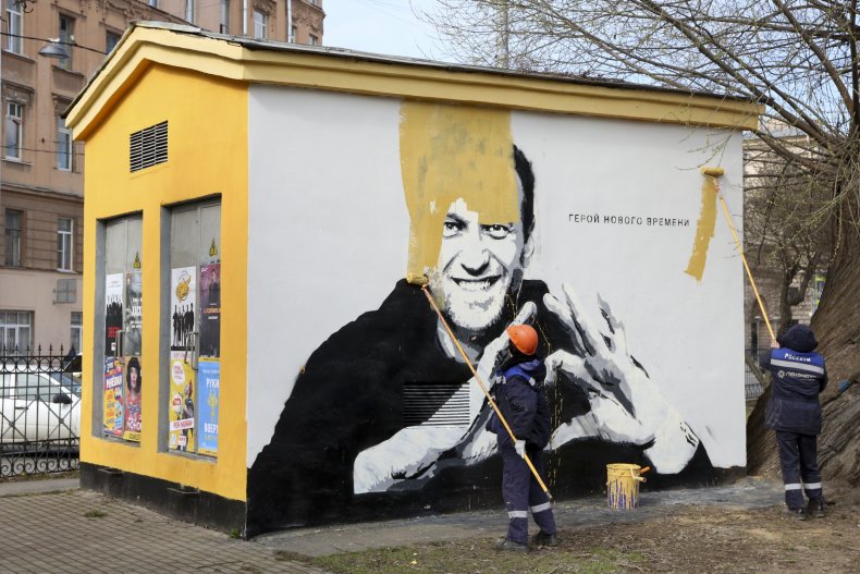 Workers Remove Navalny Graffiti
