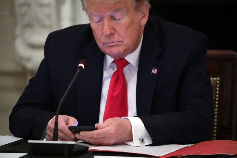 Former President Trump Looks at His Phone