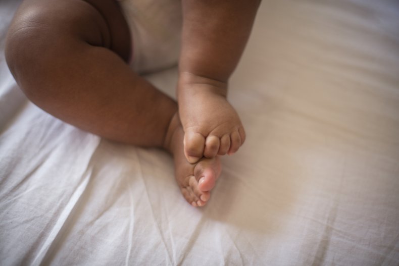 A baby lying on bed