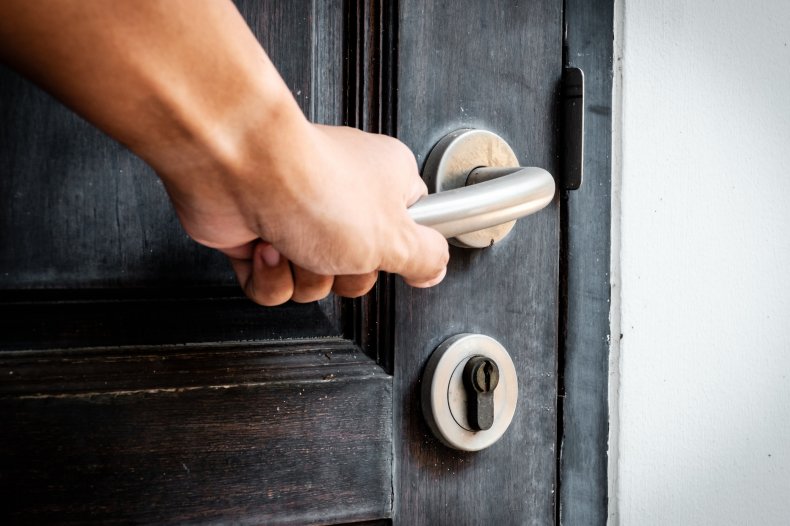 Stock image of someone opening a door