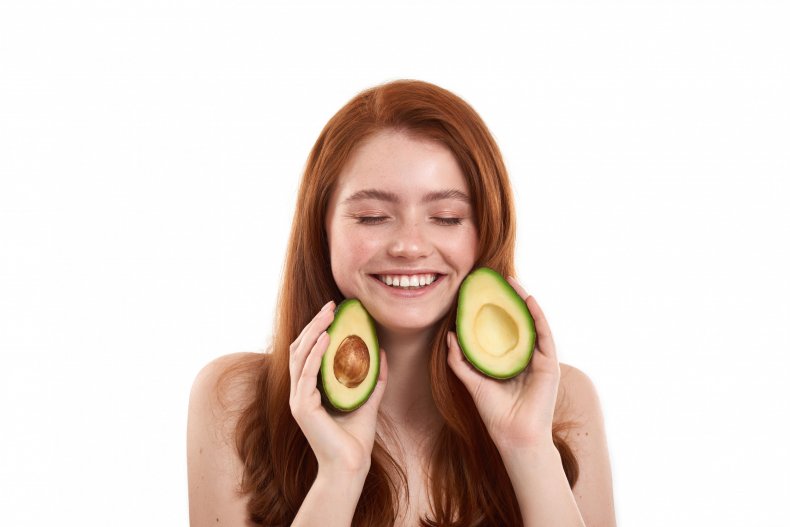 Woman holding avocado