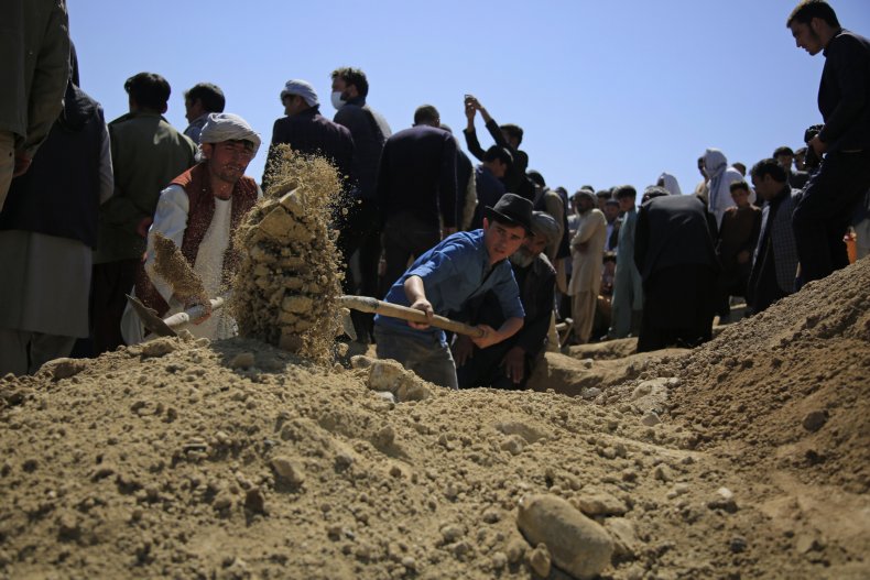 Afghan Men Bury Bombing Victim