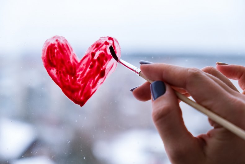 Woman painting a love heart