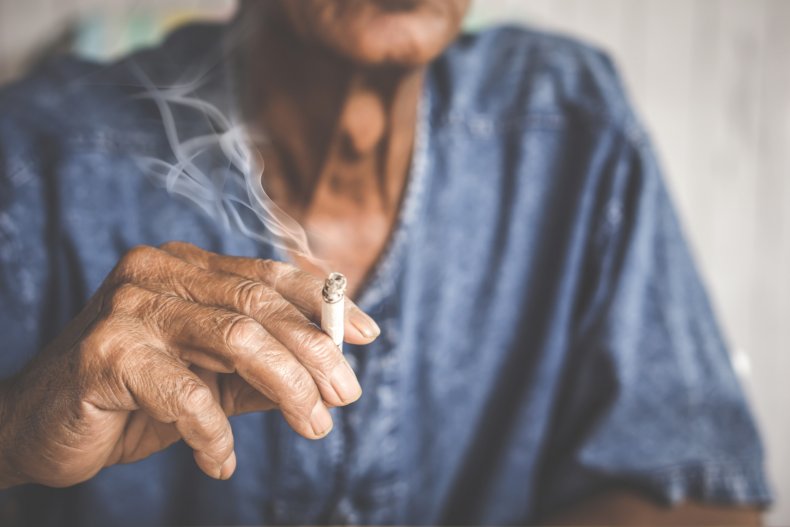 Hand holding a cigarette smoking