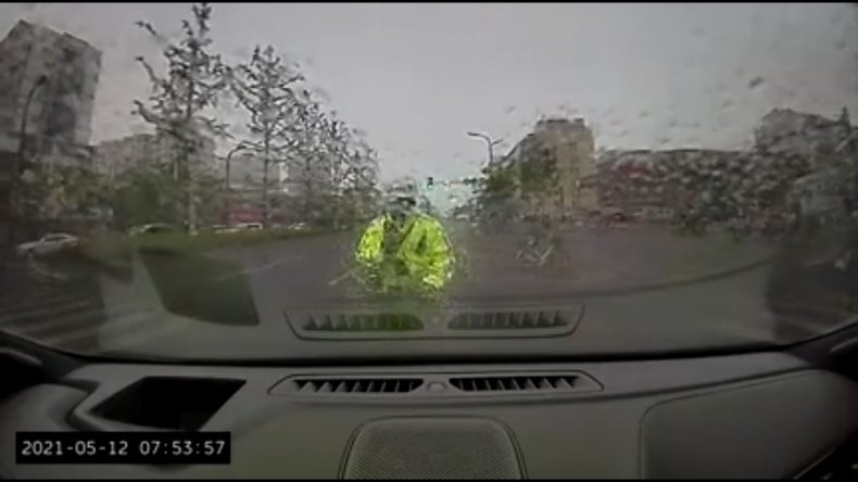 Driver Rams Traffic Cop Along Road