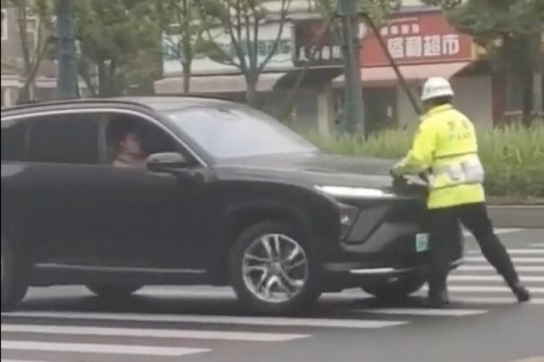 Driver Rams Traffic Officer Along Road