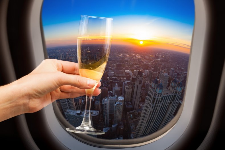 Woman holding wine on a plane