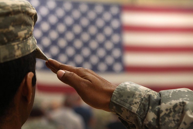 soldier salutes flag