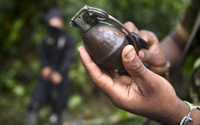 A man holds a live grenade.