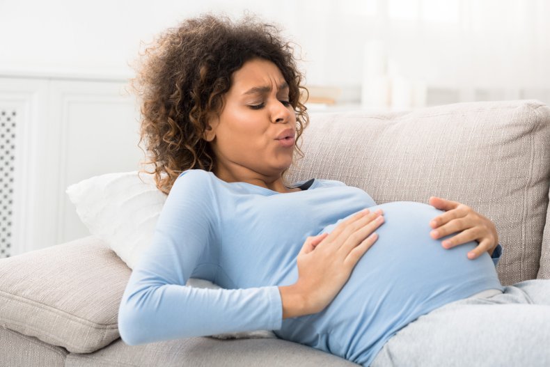 A pregnant woman nursing bump