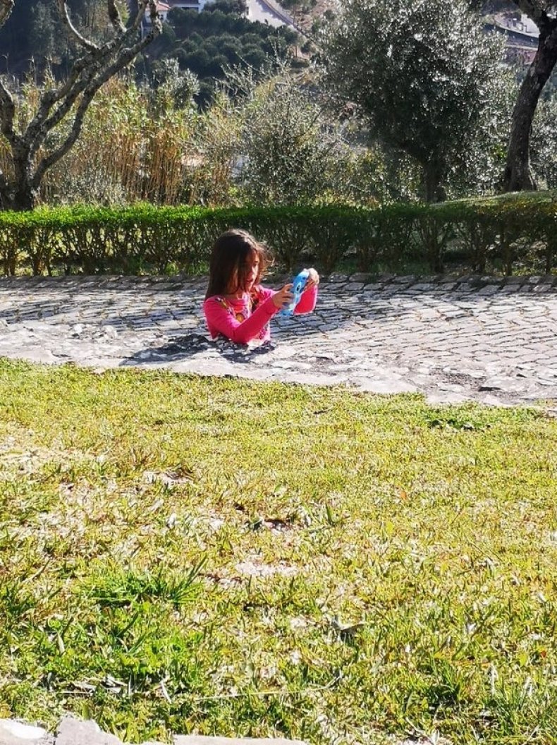 Optical illusion of girl in pavement