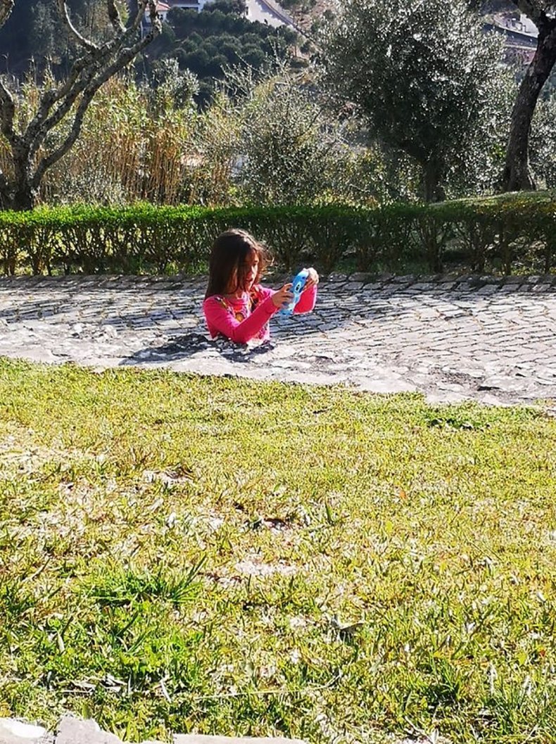 Optical illusion of girl in pavement