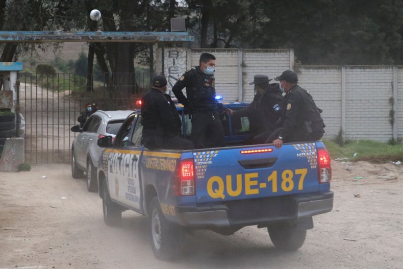 Police officers enter the prison