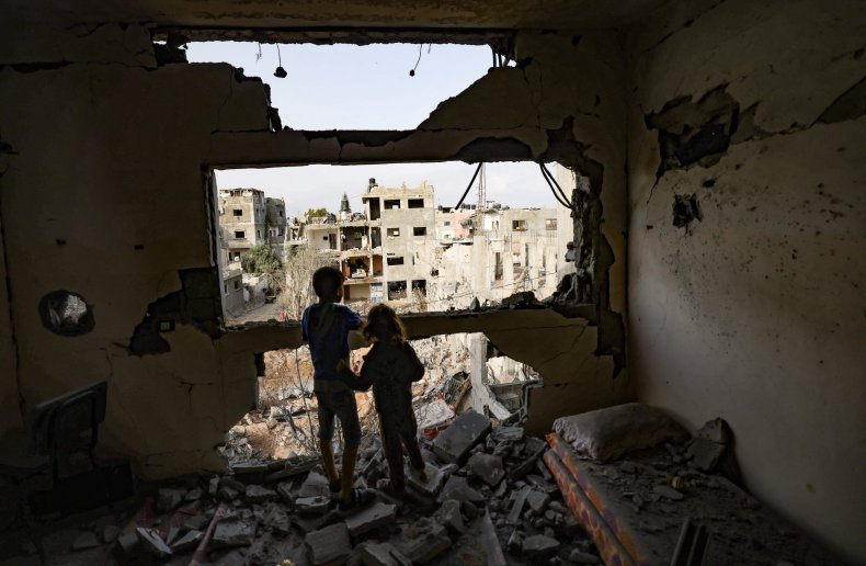 Palestinian children in their bombed home Gaza