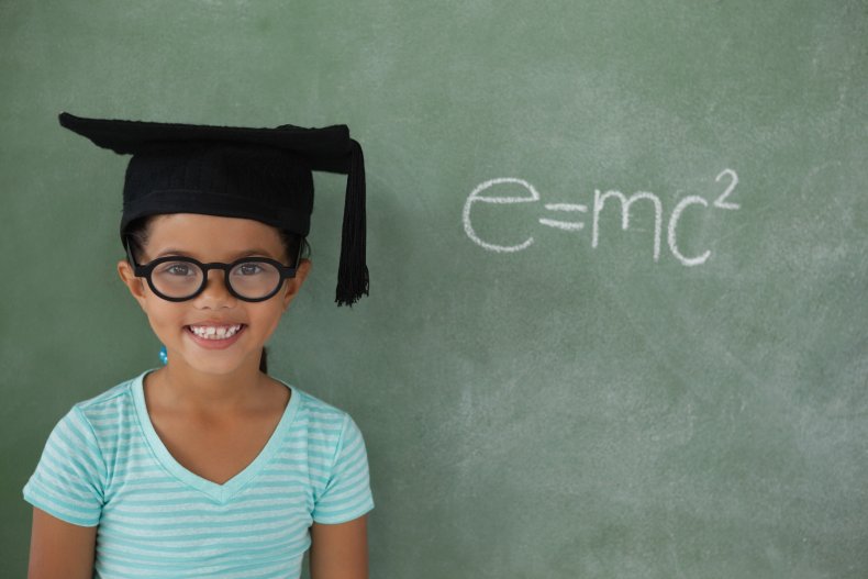 Little girl wearing a graduation cap