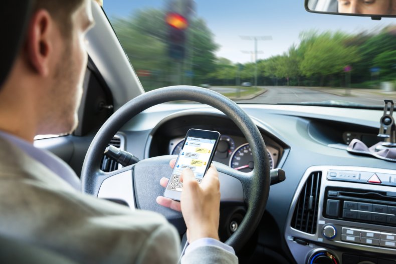 Stock image of man texting and driving