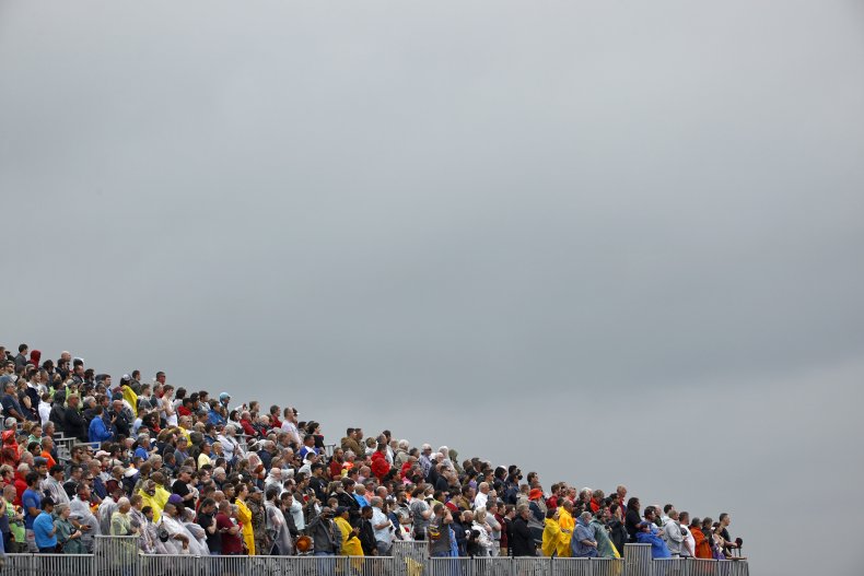 NASCAR race attendees stand for anthem.