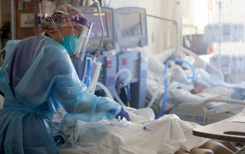 A registered nurse cares for COVID-19 patients