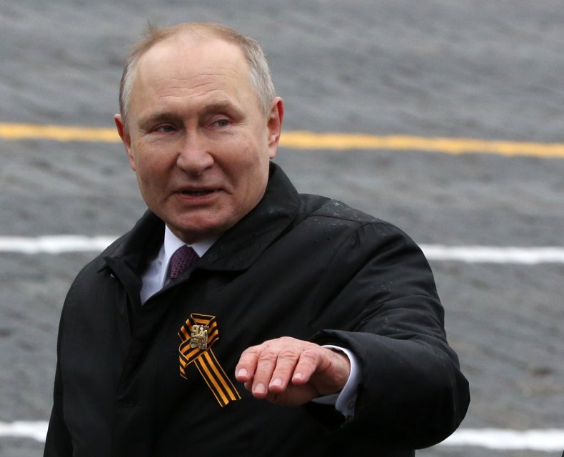 Russian President Vladimir Putin waves 