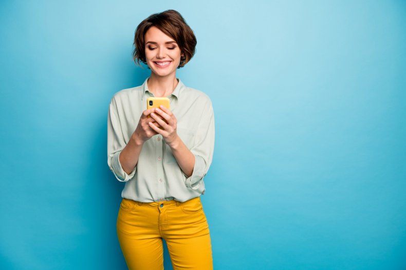 woman smiling at phone