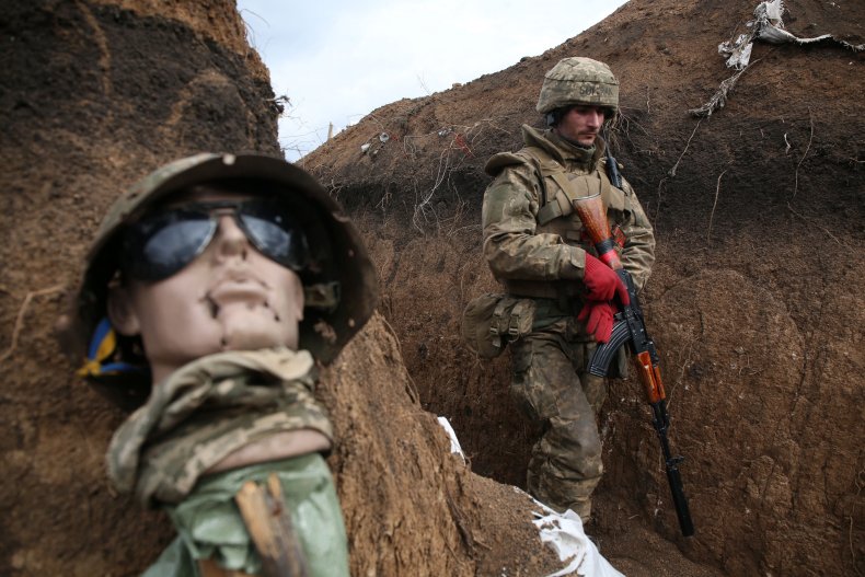 Ukrainian serviceman walks in a trench