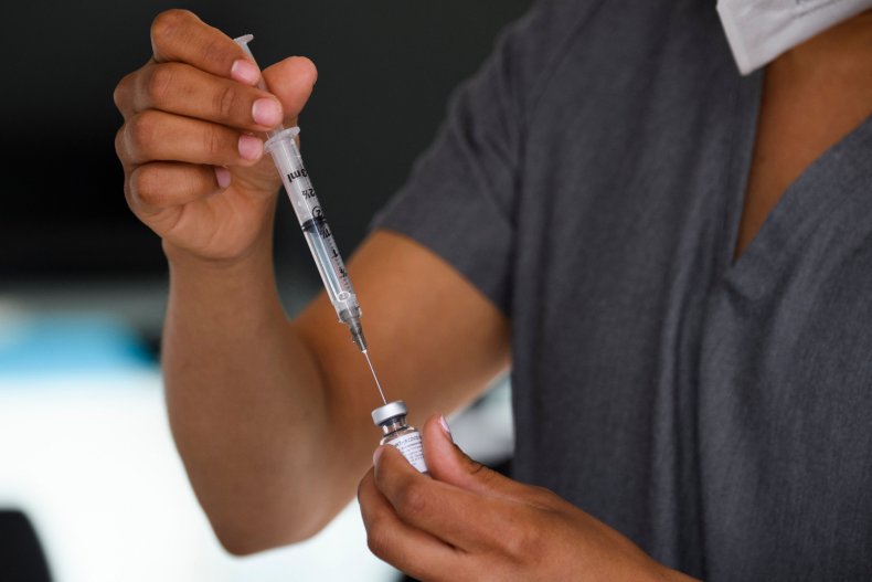 Health worker administers a COVID-19 vaccine