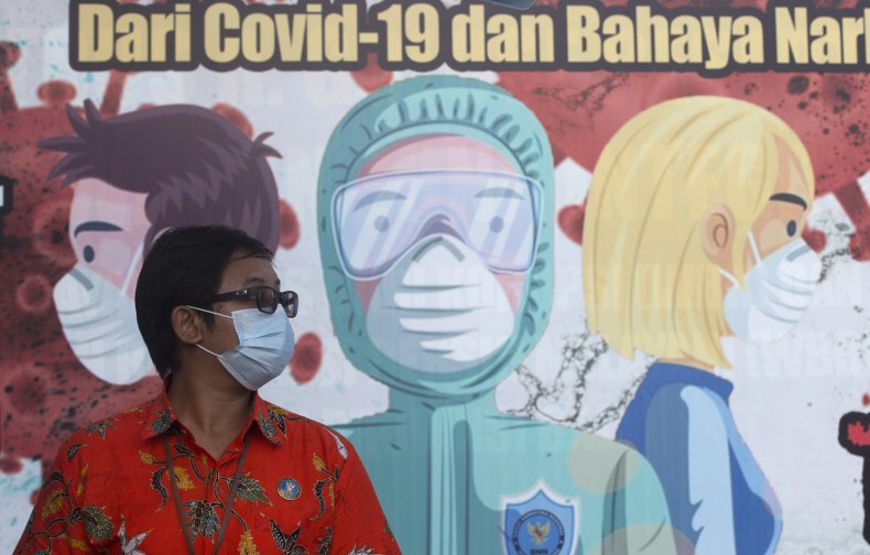 Woman in Front of Mask Mural