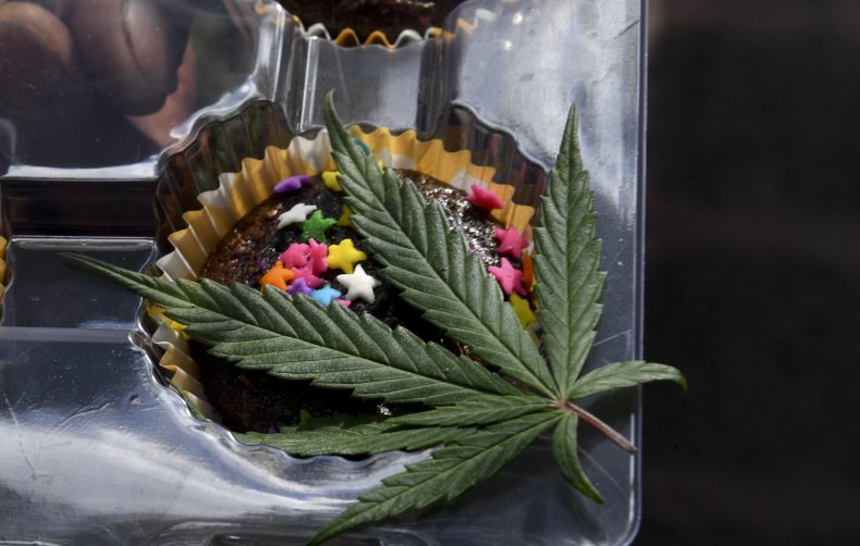 A marijuana leaf drapes a brownie.