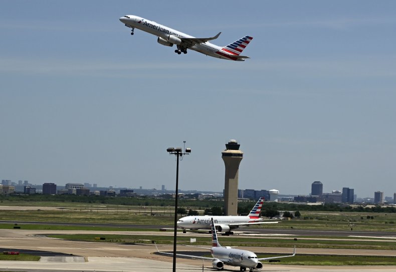 A plane flies out of an airport.