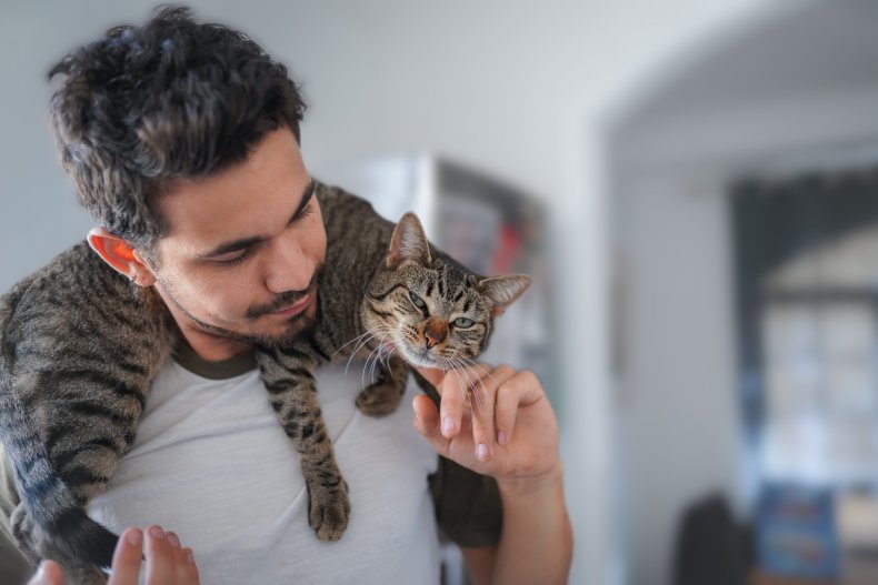 Man with cat on his shoulders