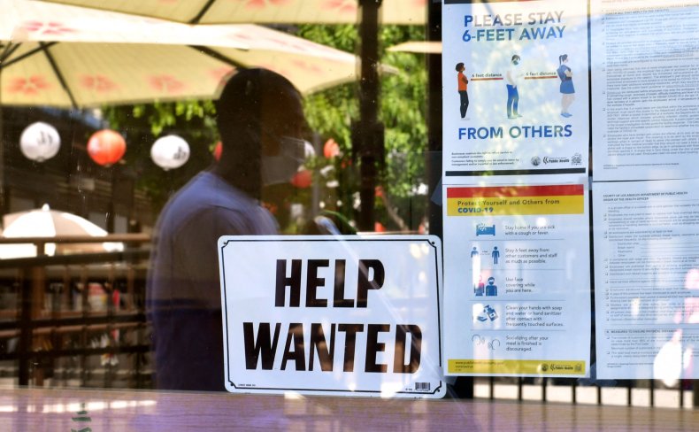 California man walks past help wanted sign