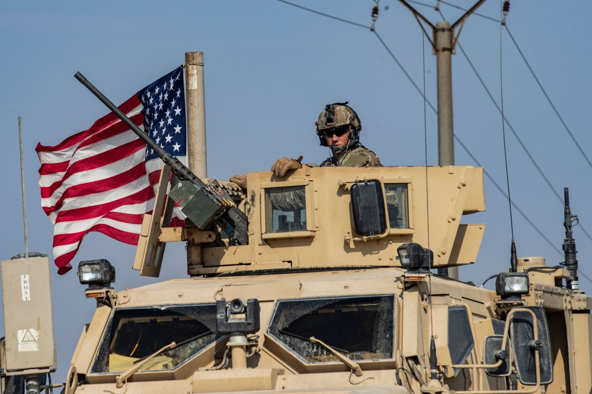 Soldier sits atop a U.S. military vehicle