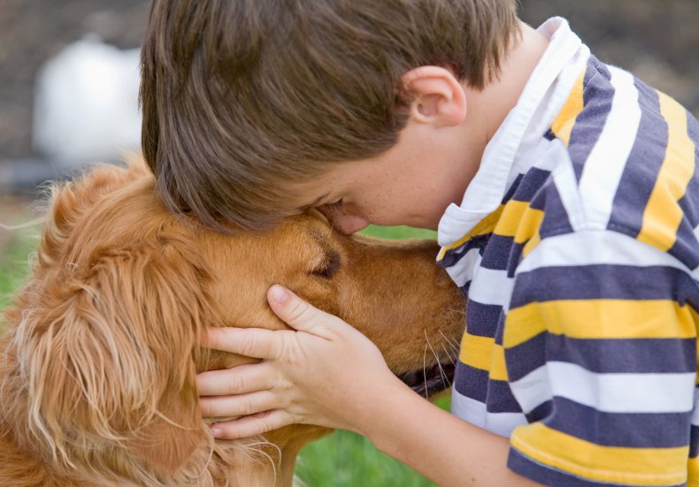 Boy hugging his dog