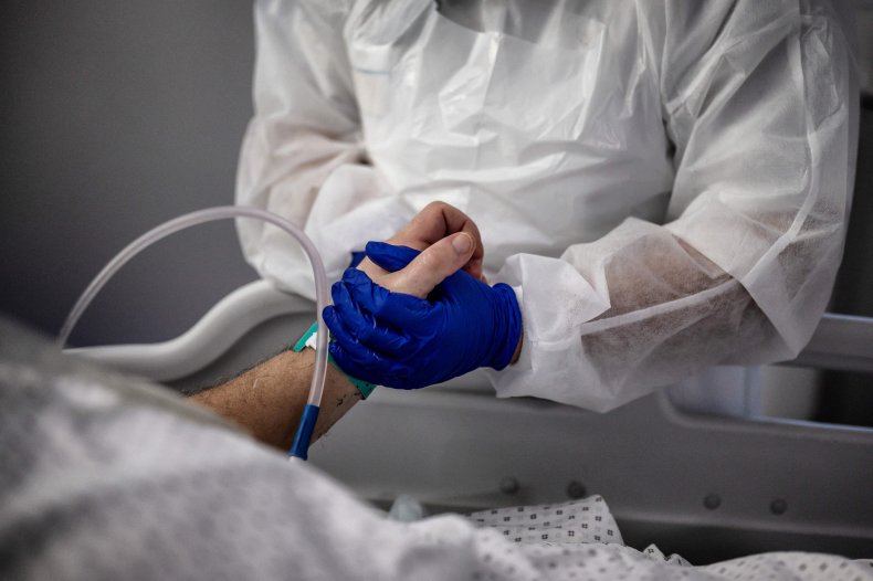 A nurse tends to a COVID-19 patient.