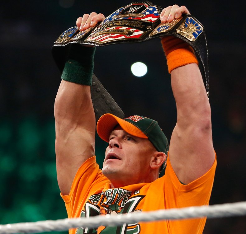 John Cena holding up wrestling belt