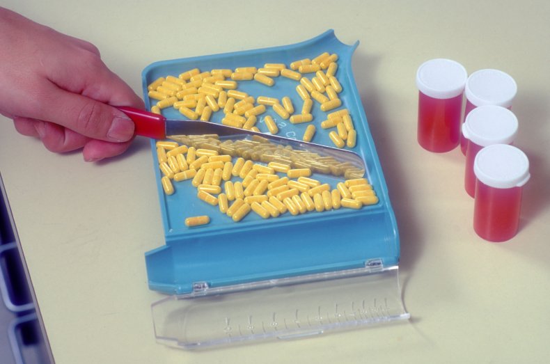 A pharmacist fills out prescriptions