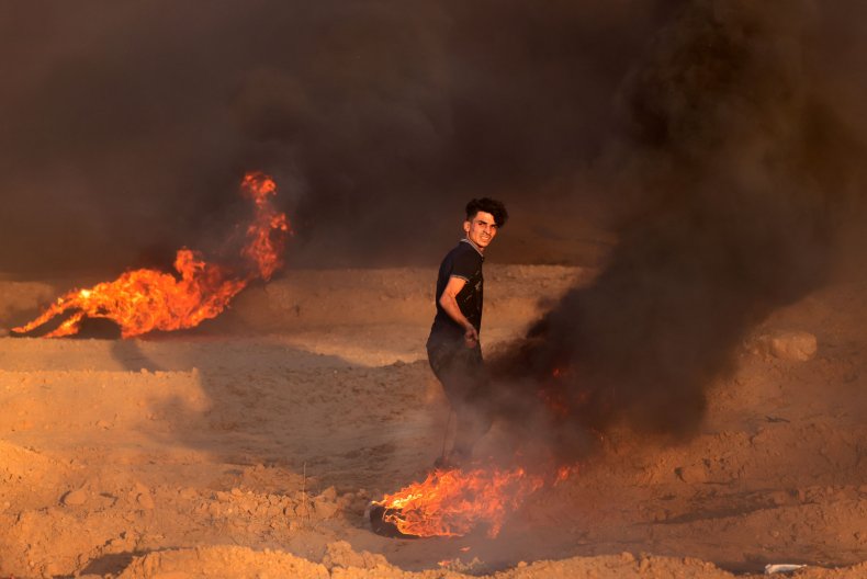 Palestinian Protester Sets Tires on Fire