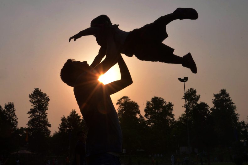 A father plays with his son