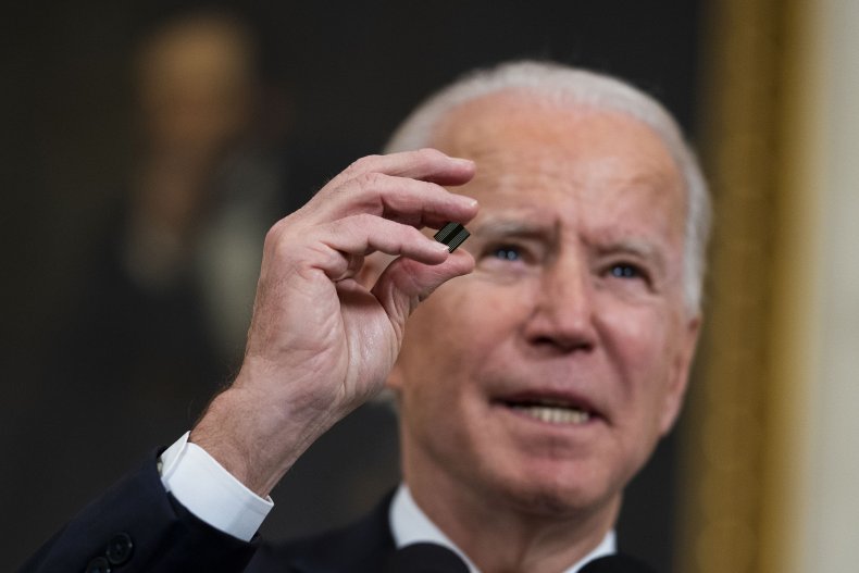 President Joe Biden holds a semiconductor