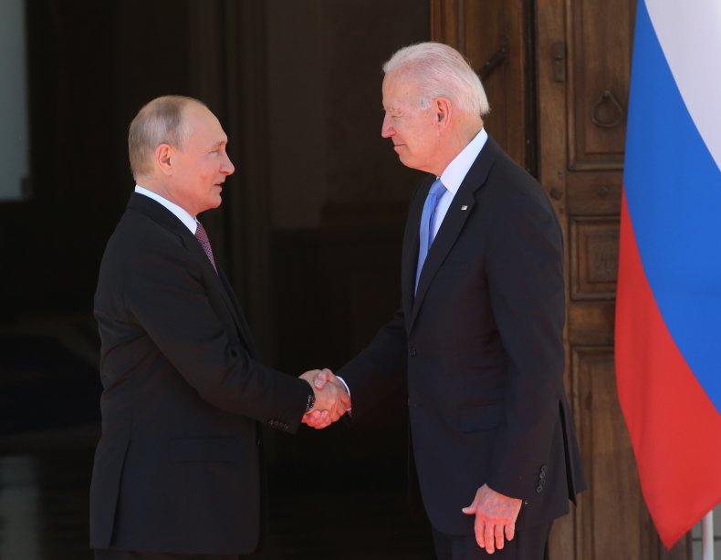 Vladimir Putin shakes Joe Biden's hand