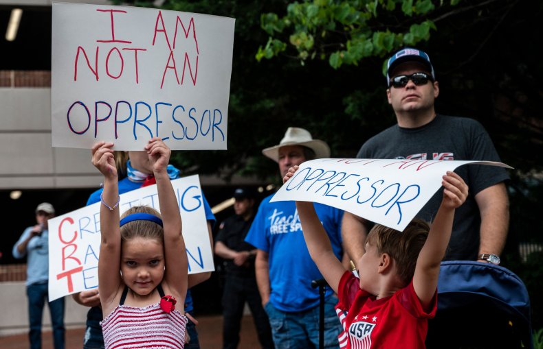 People hold up signs during a rally