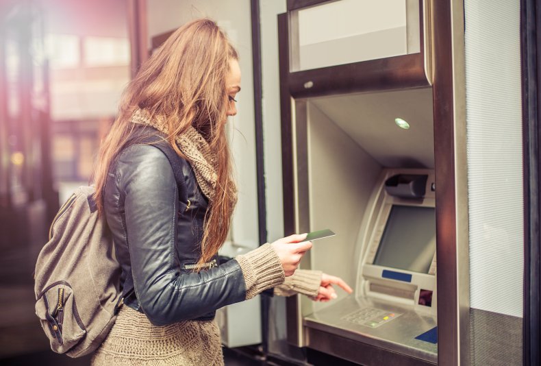Young woman using an ATM.