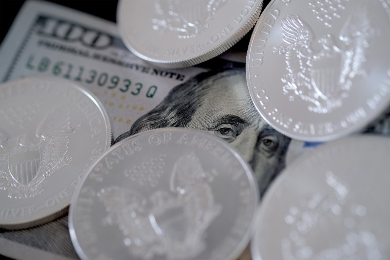 Coins and a $100 bill are shown