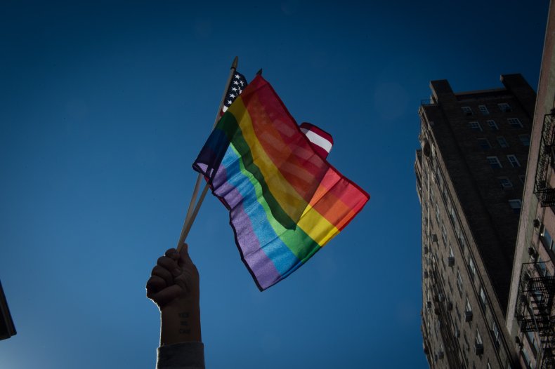 People hold signs and flags