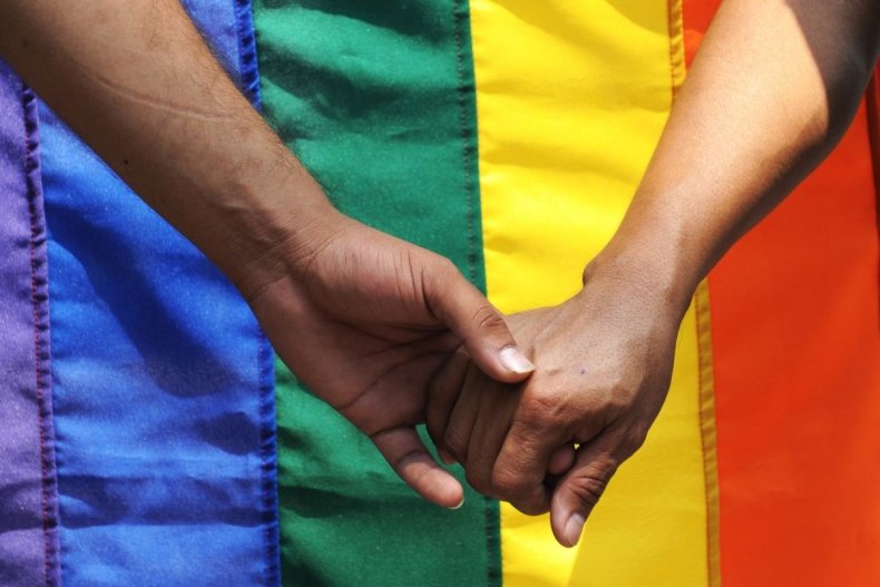 File photo of LGBT flag with hands