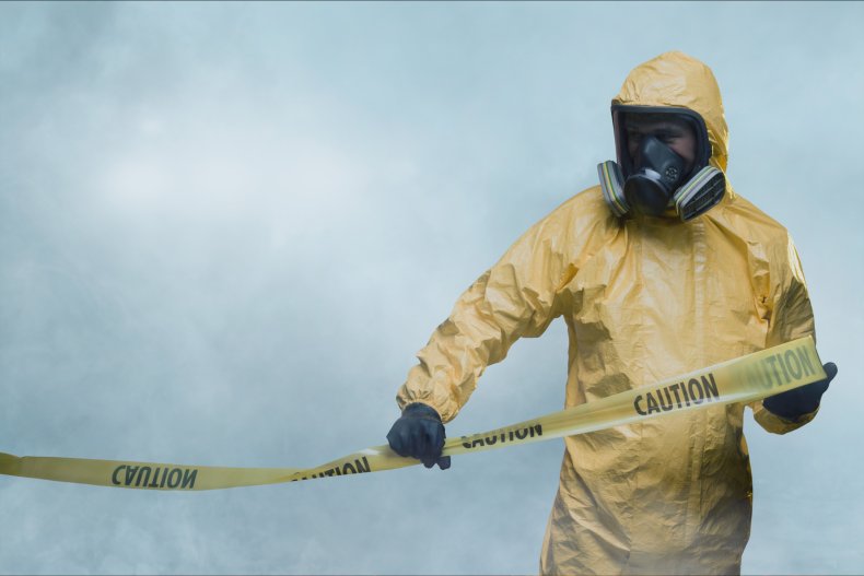 Man in a hazmat cleaning suit