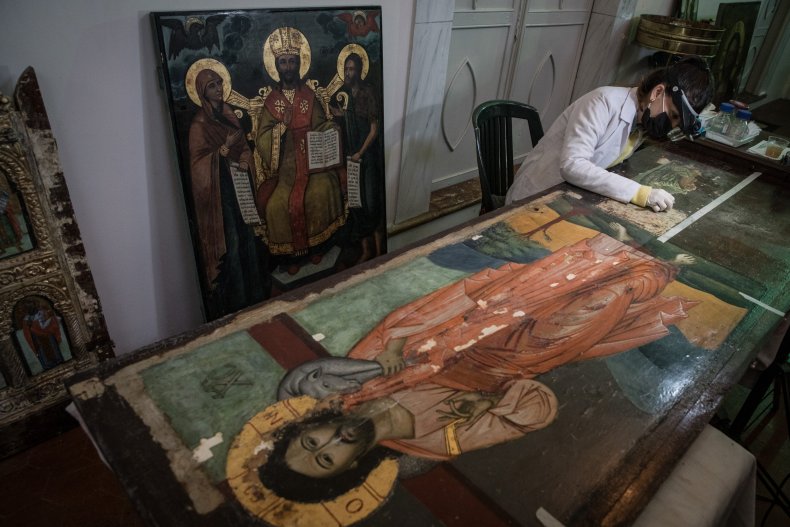 Restoration assistant Asli Erel cleans icon