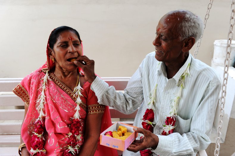 Indian Groom Feeds His Bride a Sweet